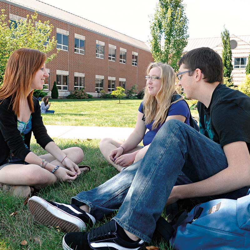 Group of students outside at table