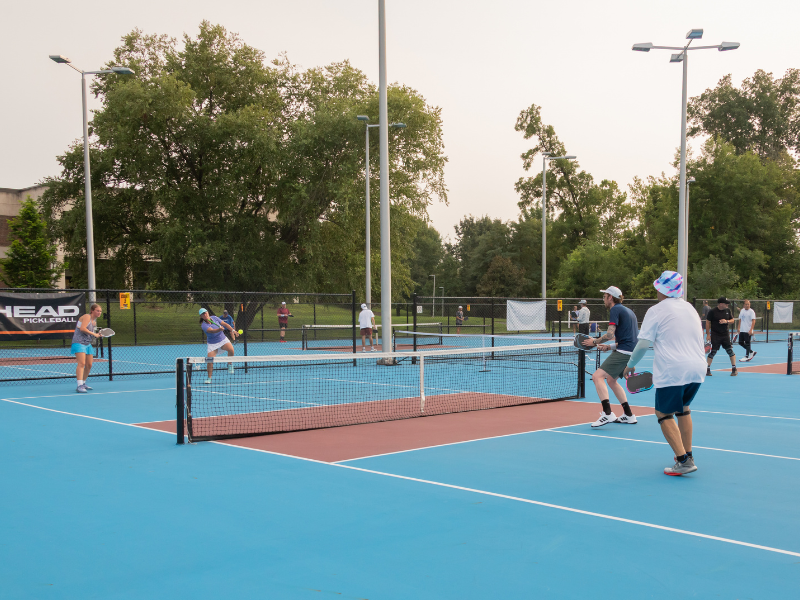Several individuals playing pickleball.